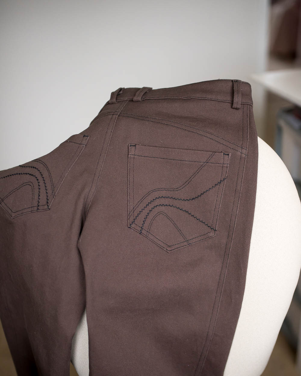 Back pocket detail. Brown jeans