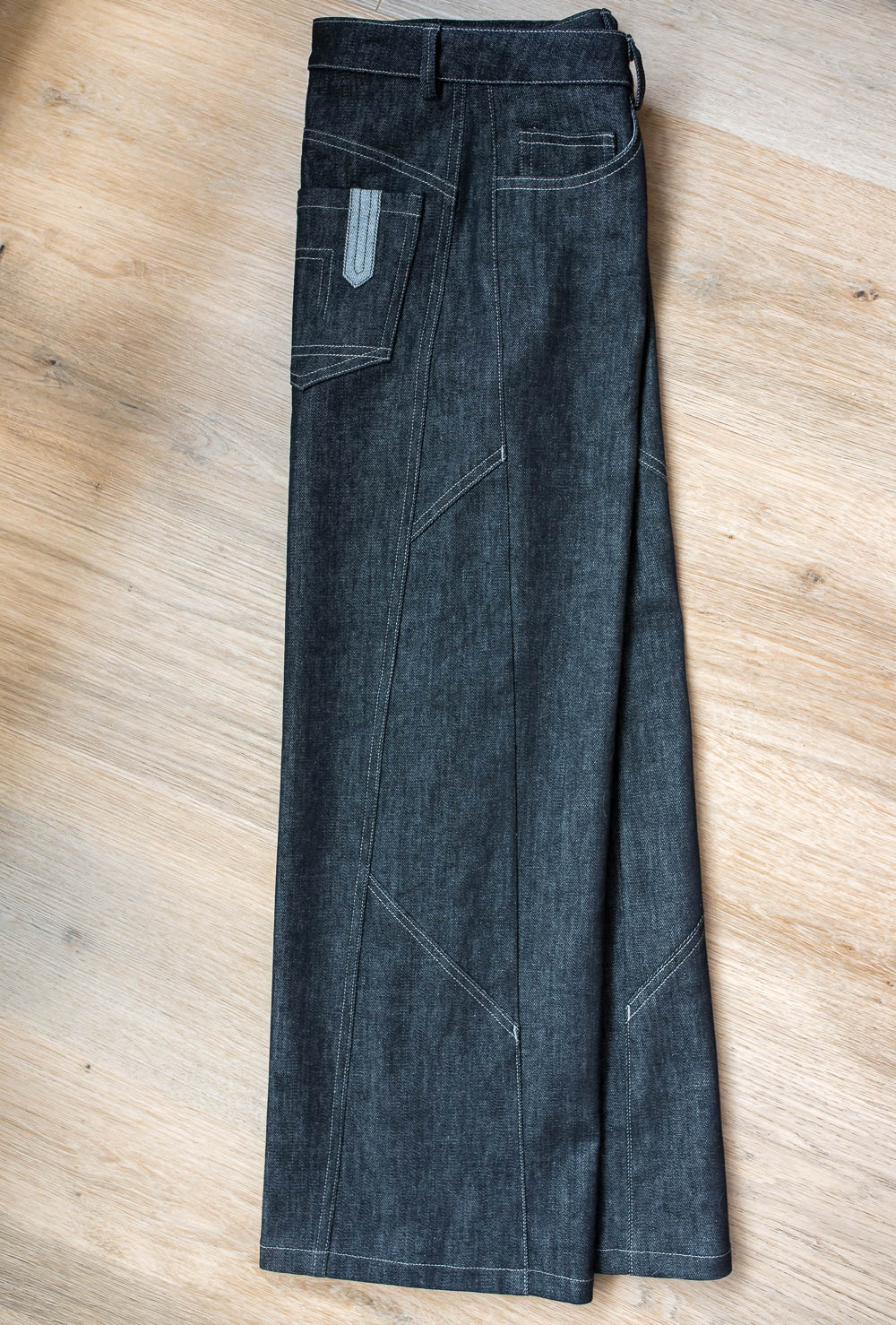 Topstitch details on side panel of black jeans